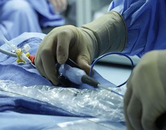 Clinician performing catheter insertion procedure