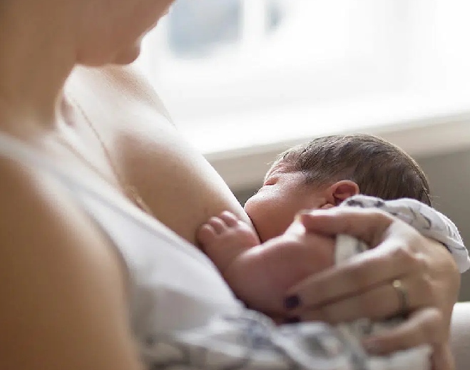 Parent holding newborn baby closely