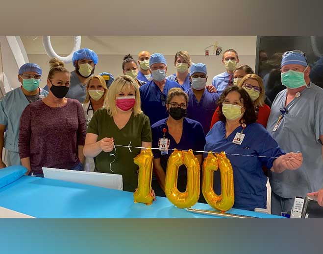 Healthcare staff celebrating milestone with balloons