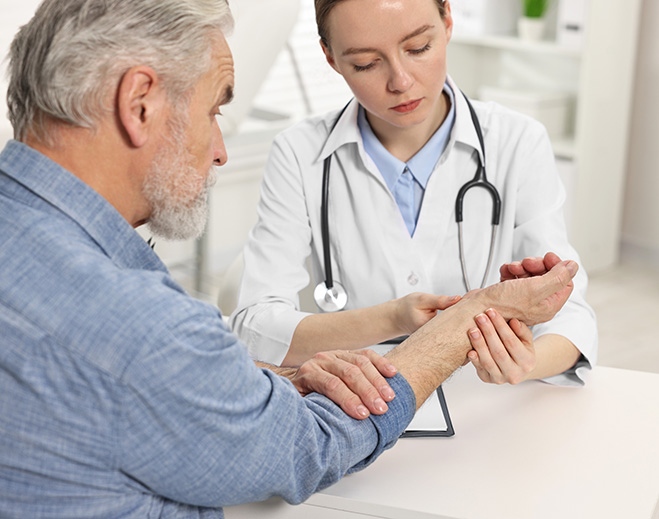 Clinician examining patient wrist in office