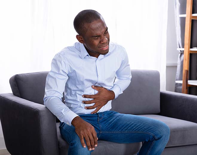 Person holding stomach in discomfort