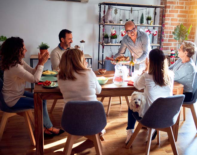 Group gathered around dining table at home