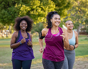 Three women jogging together outdoors