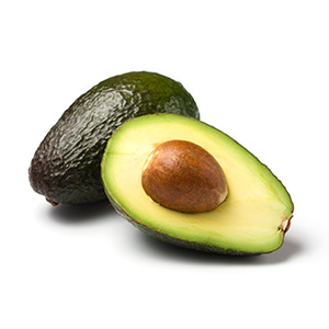 Whole and halved avocado with pit