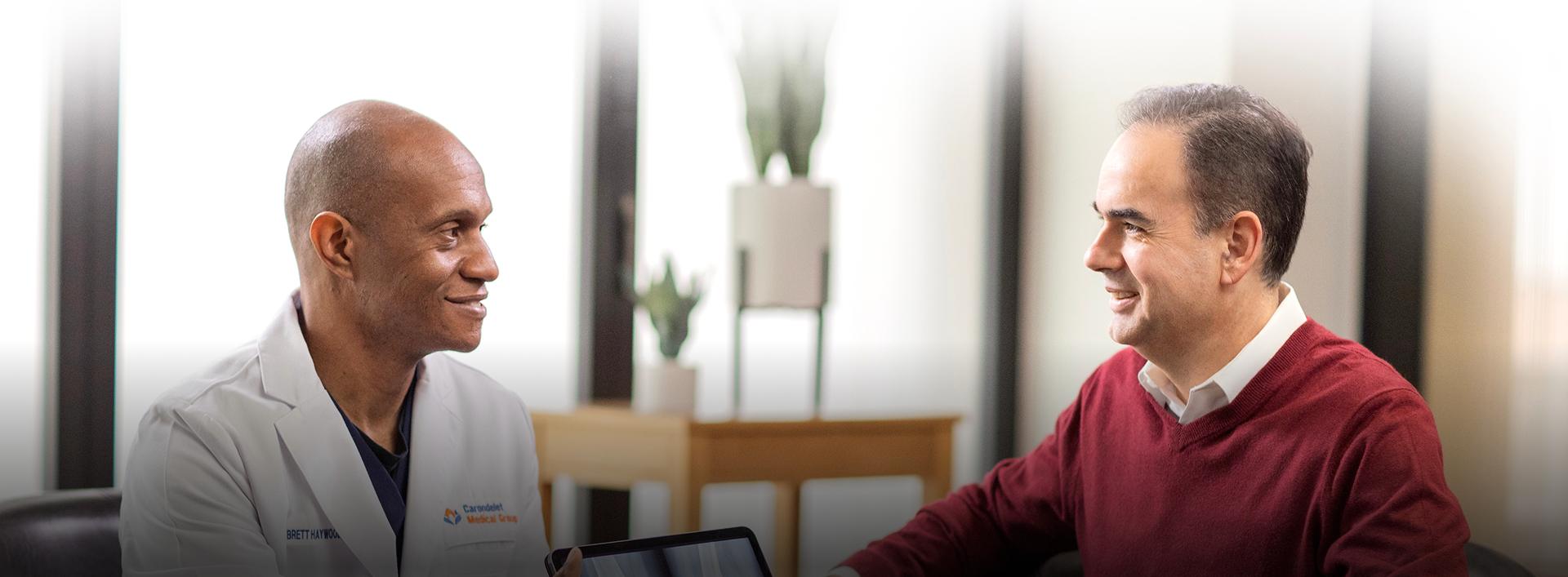 Physician consulting patient in clinic office