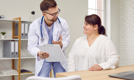 Doctor reviewing medical chart with patient